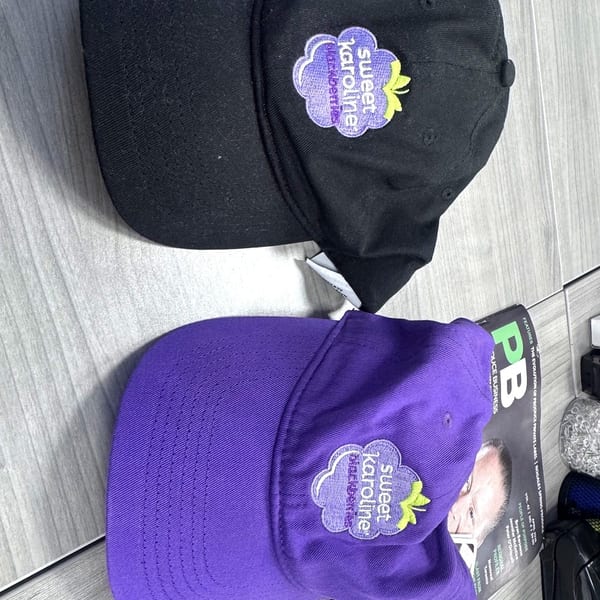 Black and purple custom caps produced with sublimation printing Miami