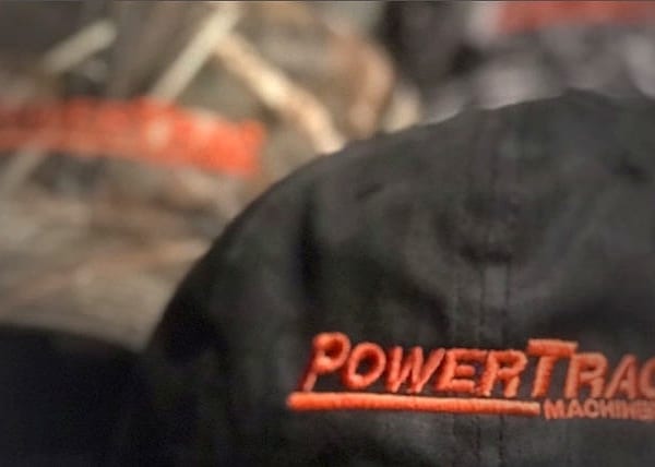 PowerTrac Machinery branded black cap with vinyl heat transfer Miami